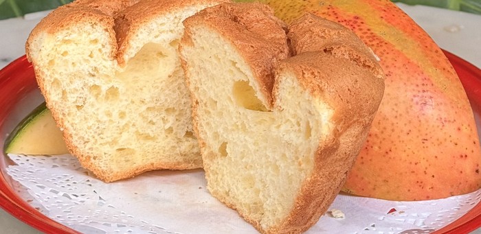 Mango spongie cake on a plate with fresh mango