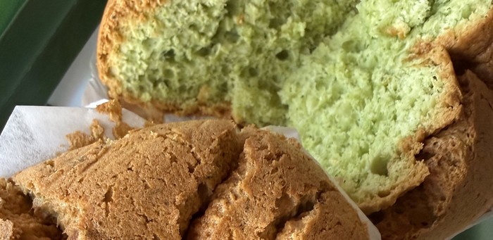 Pandan Coconut spongie cake sliced open showing green pandan crumb